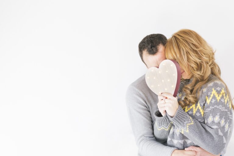 A happy couple hold hands, smiling at each other as they enjoy peaceful moments together after childbirth.